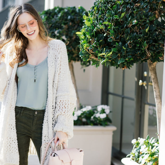 Alyssa Campanella of The A List blog wearing Free People Saturday Morning comfy sweater, Senreve mini Maestra bag, and Current Elliott Stiletto jeans