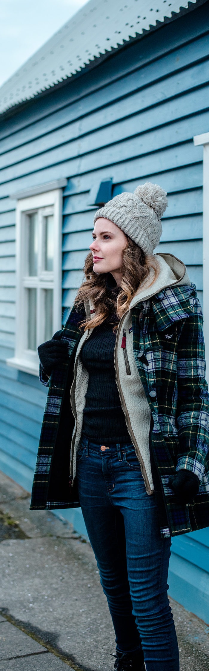 Alyssa Campanella visits Isafjordur in Westfjords, Iceland wearing Gloverall plaid duffle coat
