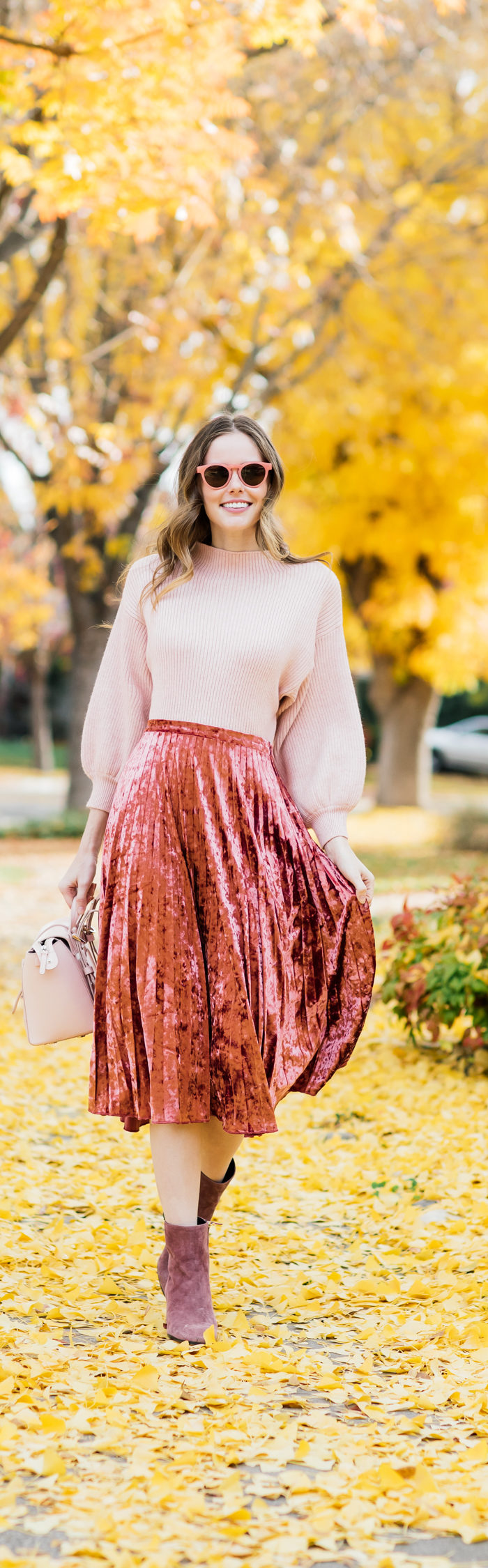 Alyssa Campanella of The A List blog wearing holiday pink in Glamorous velvet skirt, Line and Dot Alder sweater, Senreve Mini Maestra bag, and M. Gemi Corsa boots