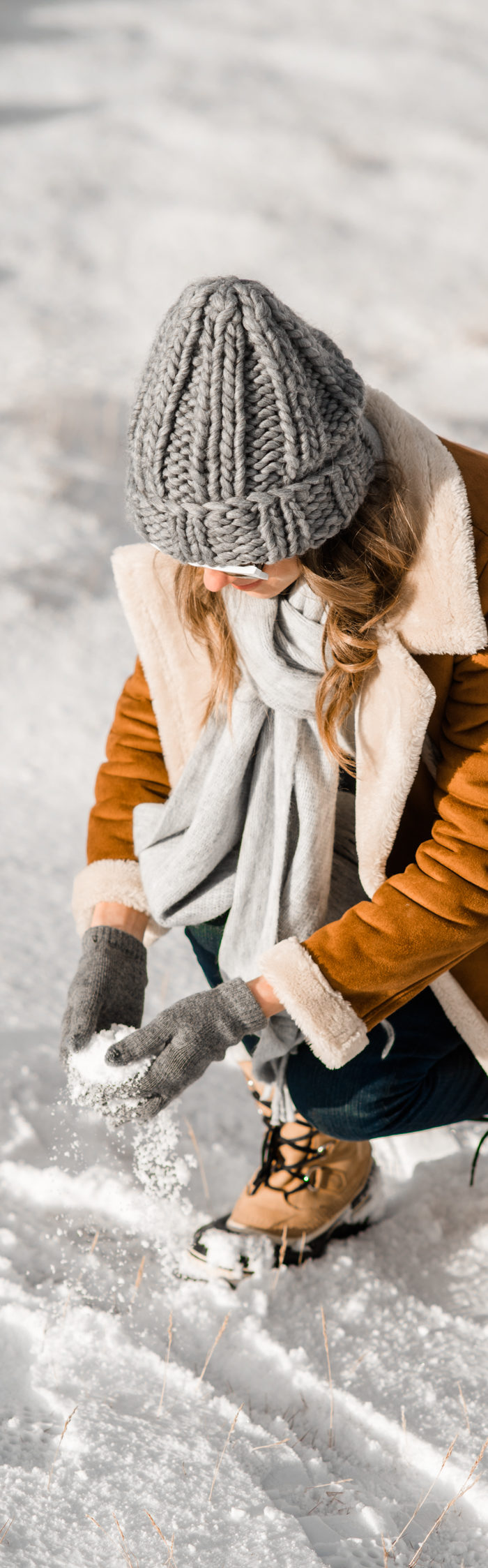 Alyssa Campanella of The A List blog plays in the snow in South Iceland wearing Topshop faux shearling coat, Sorel Caribou boots, and Illesteva Leonard II sunglasses