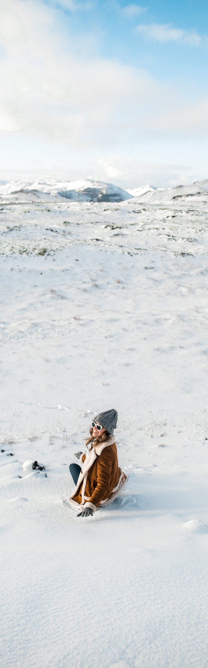 Alyssa Campanella of The A List blog plays in the snow in South Iceland wearing Topshop faux shearling coat, Sorel Caribou boots, and Illesteva Leonard II sunglasses