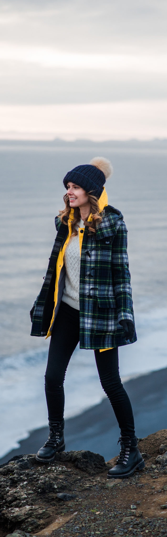 Alyssa Campanella of The A List blog wearing Gloverall plaid coat at Dyrhólaey on a road trip from Akureyri to Vik, Iceland