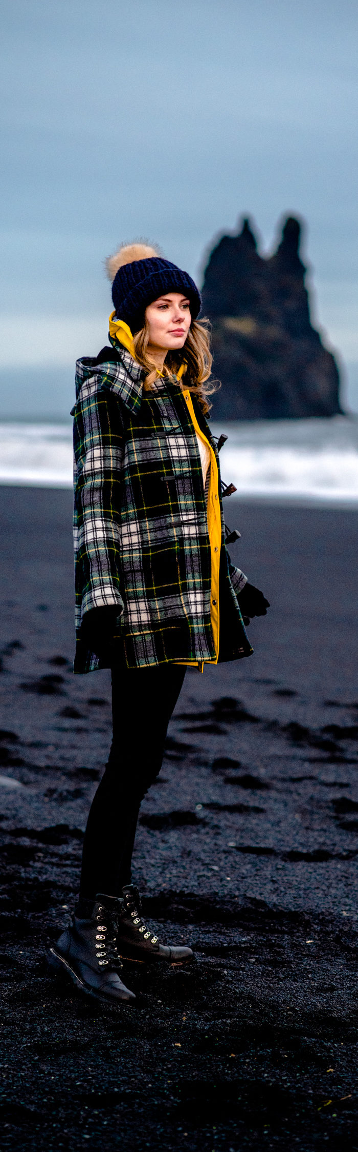 Alyssa Campanella of The A List blog wearing Gloverall plaid coat at Reynisfjara black sand beach on a road trip from Akureyri to Vik, Iceland