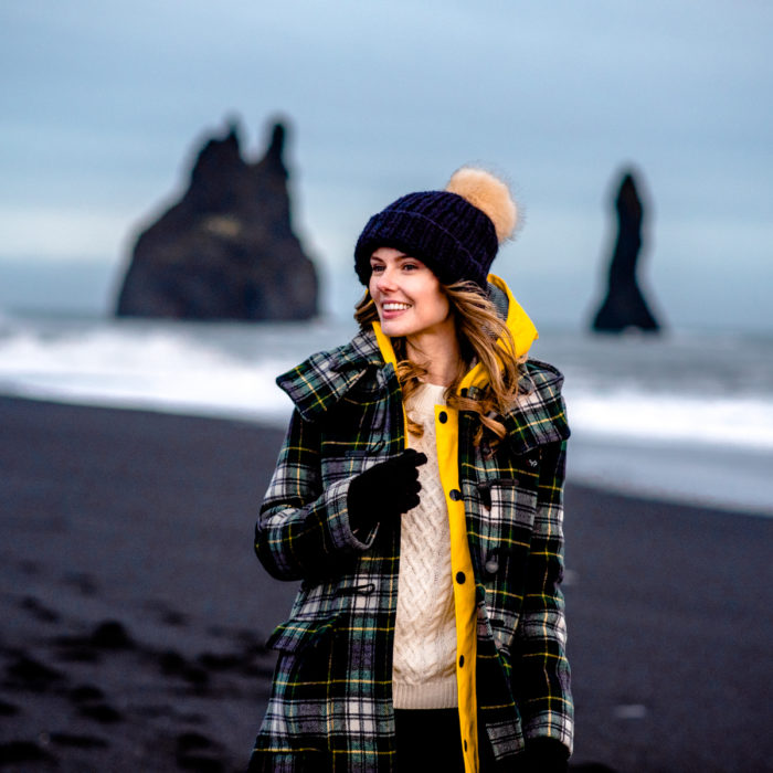 Alyssa Campanella of The A List blog wearing Gloverall plaid coat at Reynisfjara black sand beach on a road trip from Akureyri to Vik, Iceland