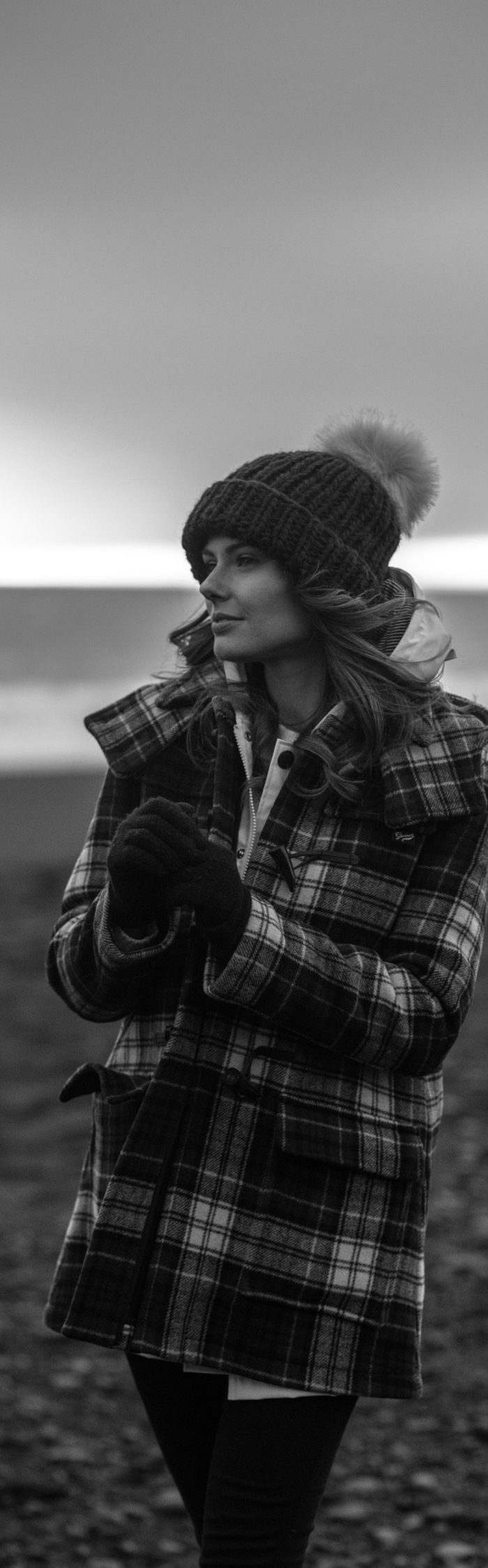 Alyssa Campanella of The A List blog wearing Gloverall plaid coat at Reynisfjara black sand beach on a road trip from Akureyri to Vik, Iceland