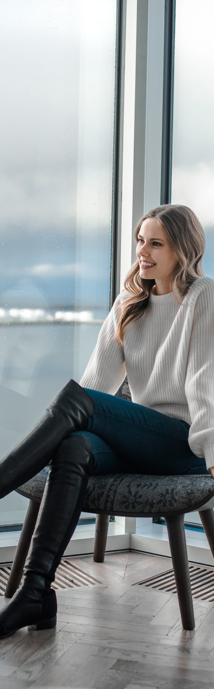 Alyssa Campanella of The A List blog stays at Tower Suites Reykjavik in Iceland wearing Demylee Carina sweater and Stuart Weitzman 5050 boots