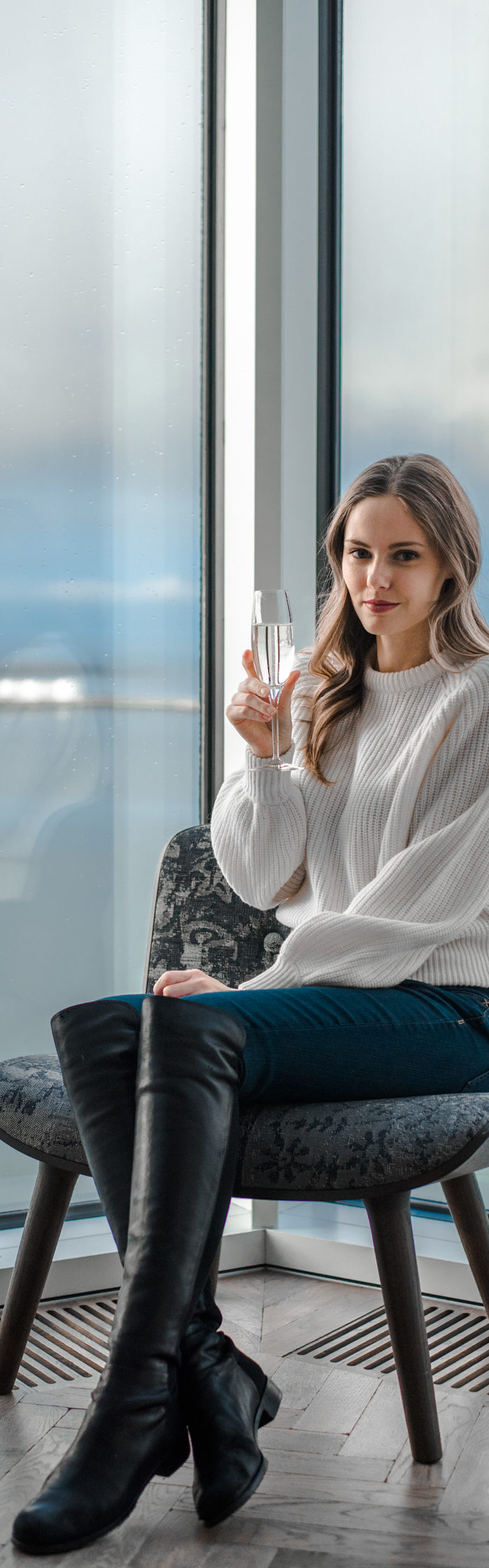 Alyssa Campanella of The A List blog stays at Tower Suites Reykjavik in Iceland wearing Demylee Carina sweater and Stuart Weitzman 5050 boots