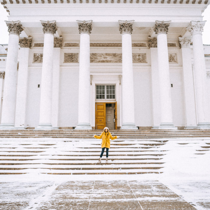 Alyssa Campanella of The A List blog shares her Helsinki City Guide wearing a yellow faux fur coat and Frye Samantha boots at the Helsinki Cathedral in Finland