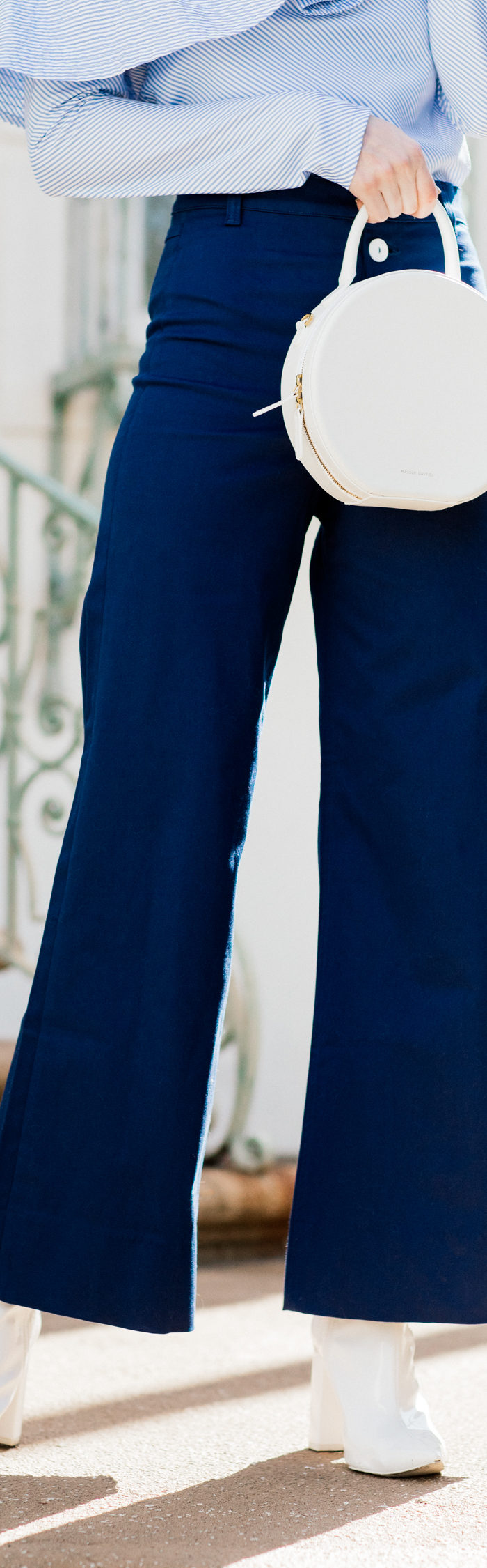 Alyssa Campanella of The A List blog shares white accessories for spring in Staud Novak pants and Mansur Gavriel white circle bag