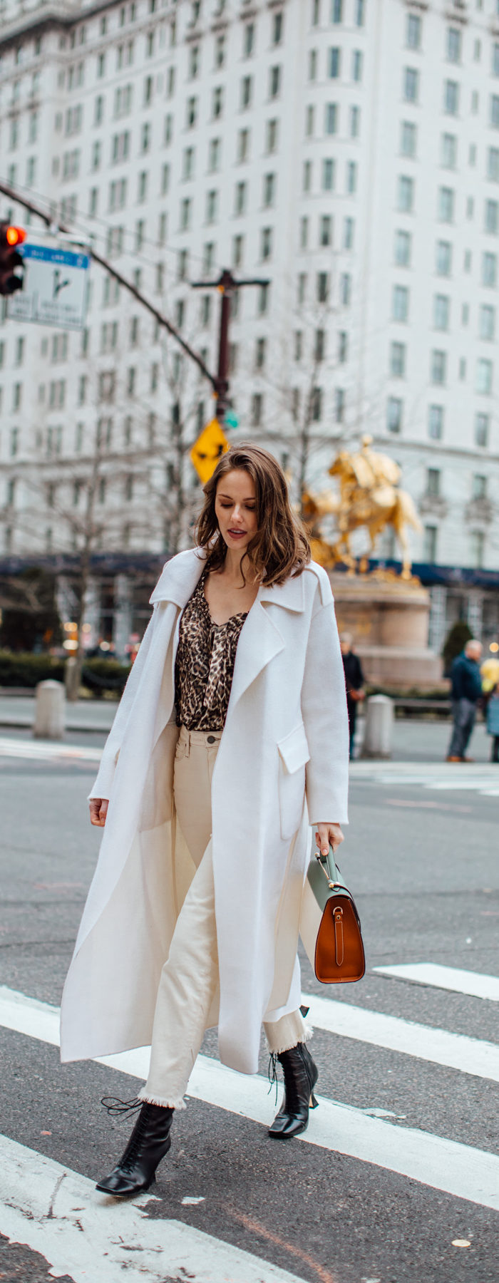 Alyssa Campanella of The A List blog shares her favorite restaurants in New York wearing Zimmermann suraya top, Strathberry midi allegro bag, and Miista yana boots.